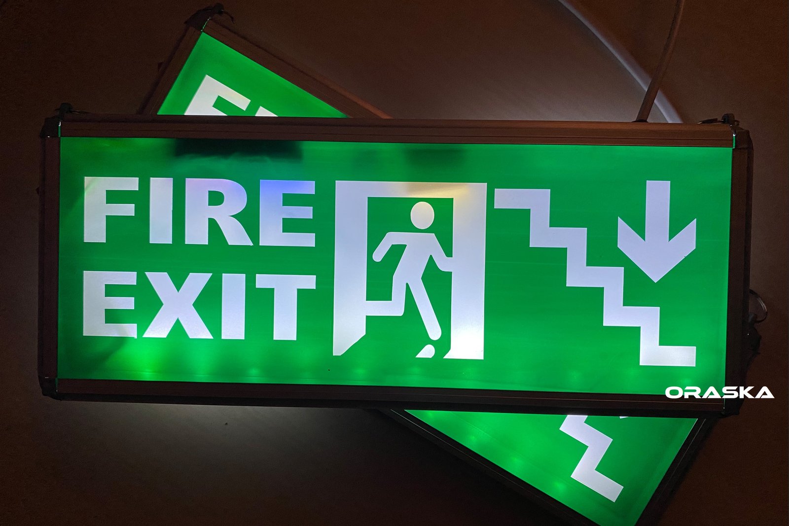 ORASKA SparkPro W-2616 – 7W Dual-Sided Green-White Fire Exit Man Arrow Sign, 500+ LUX, 8.2V Li-Ion, 3–4 Hr Backup